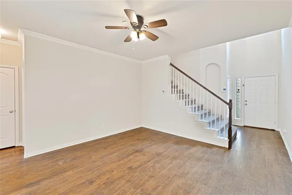 a view of entryway and hall with wooden floor