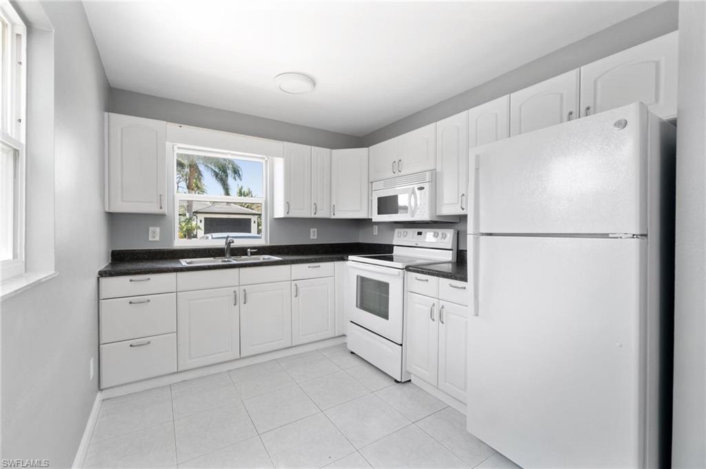 4337-4339 Mariner Road Bonita Springs, FL 34134 - Photo 13 of 29 a kitchen with cabinets stainless steel appliances and window