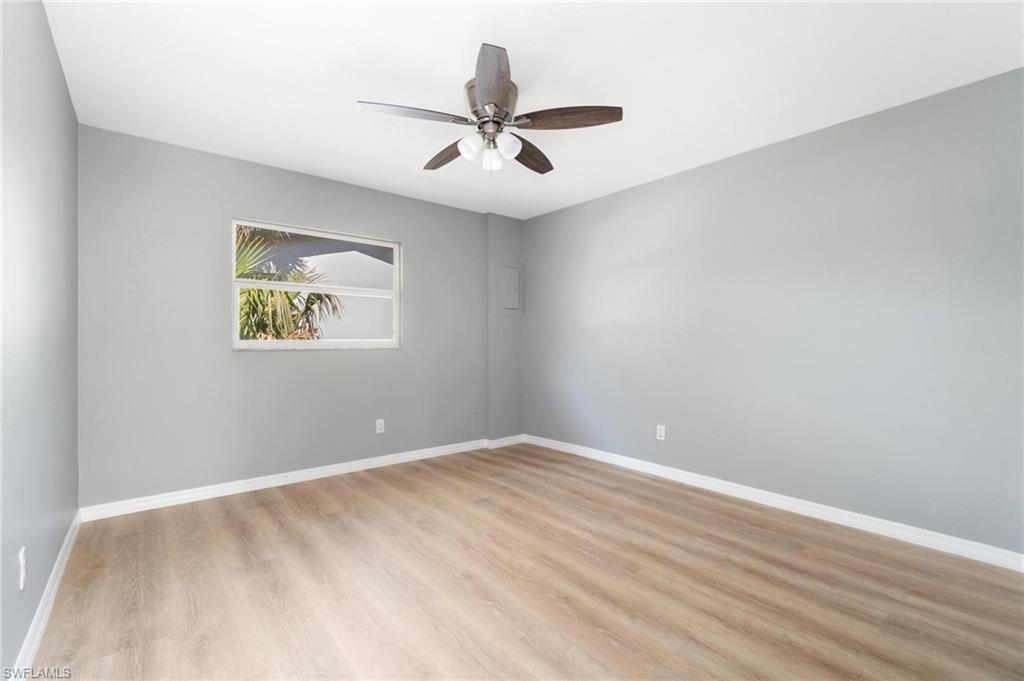 4337-4339 Mariner Road Bonita Springs, FL 34134 - Photo 15 of 29 an empty room with wooden floor and ceiling fan