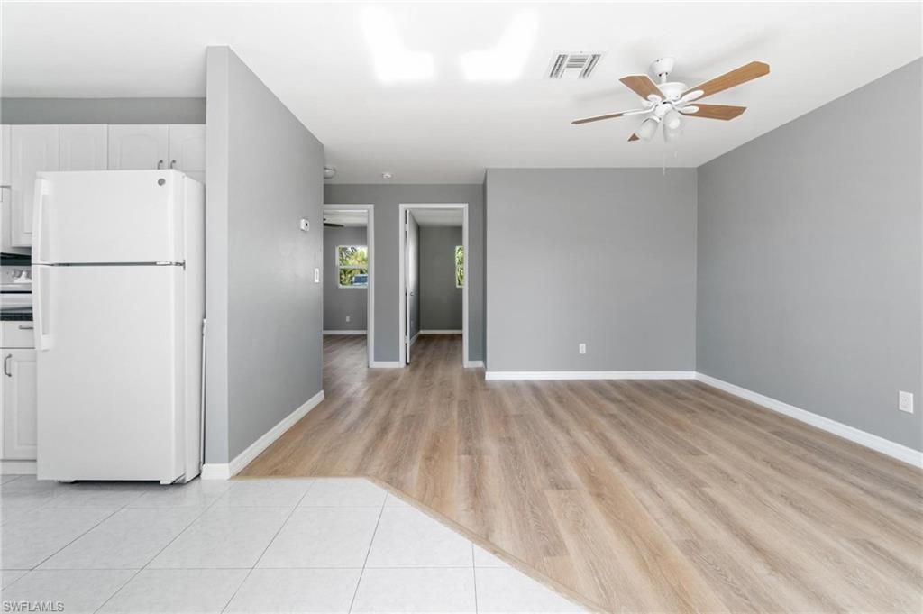 4337-4339 Mariner Road Bonita Springs, FL 34134 - Photo 7 of 29 a view of a livingroom with a hardwood floor and a ceiling fan