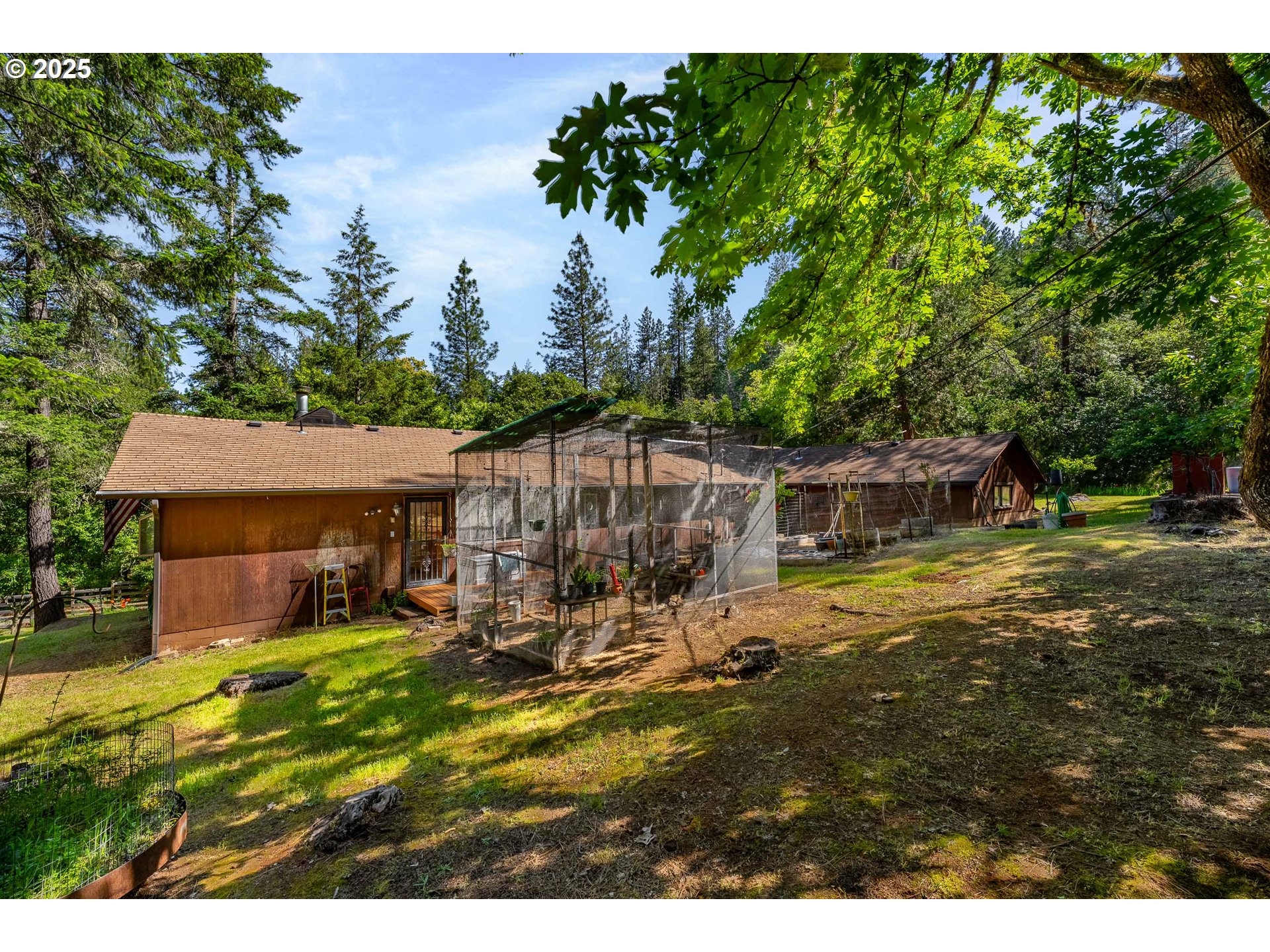 905 Summit Loop Grants Pass, OR 97527 - Photo 7 of 46 a view of a patio with table and chairs with wooden fence and plants