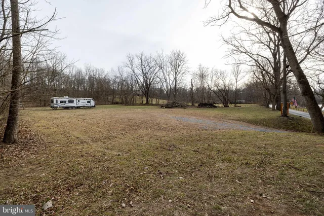 a view of a field with trees in the background