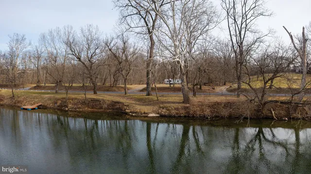 a view of a yard with wooden fence