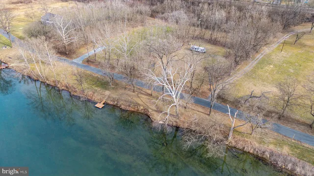 an aerial view of residential houses with lake and mountain view