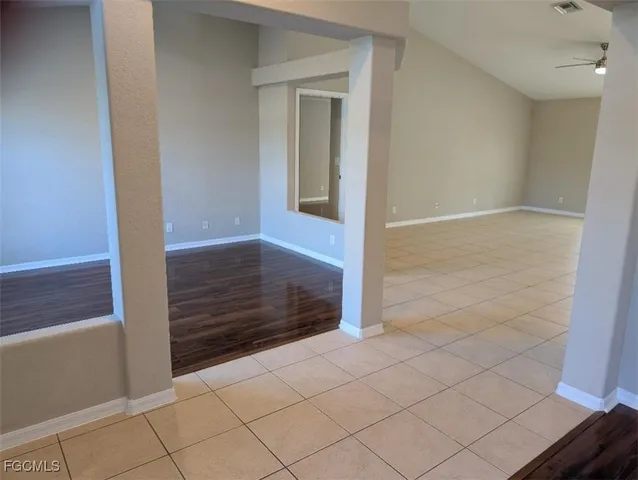 a view of an empty room and wooden floor
