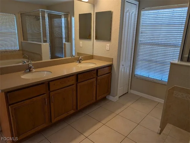 a bathroom with a double vanity sink and mirror