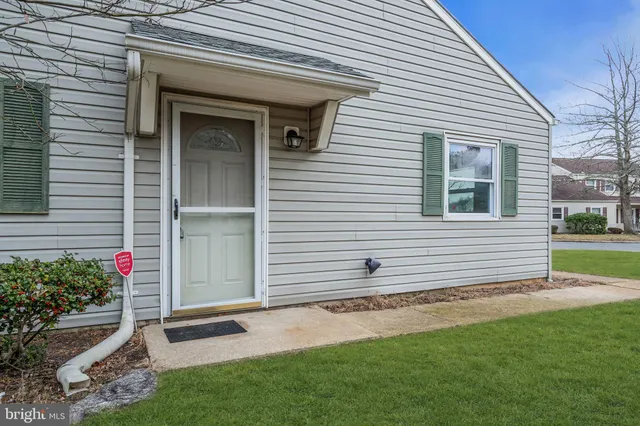 a view of a tree in front of a white house