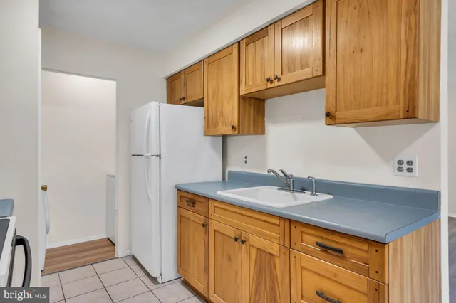 a view of kitchen with cabinets and wooden floor