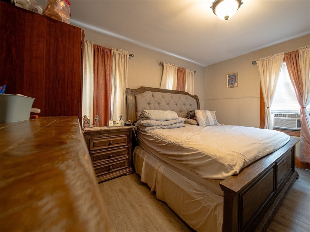42 Morton Street Lawrence, MA 01841 - Photo 11 of 24 a bedroom with a bed and wooden floor