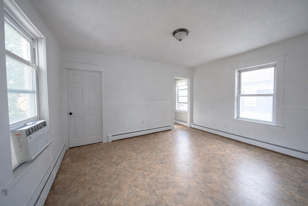 42 Morton Street Lawrence, MA 01841 - Photo 15 of 24 an empty room with wooden floor and windows