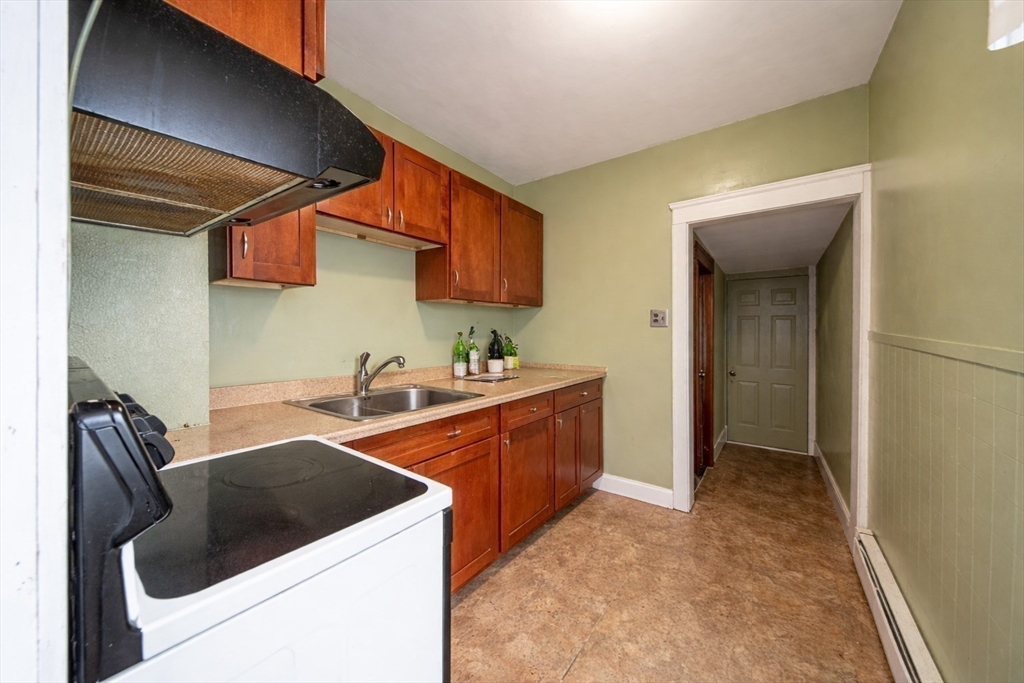 42 Morton Street Lawrence, MA 01841 - Photo 16 of 24 a kitchen that has a sink and a stove