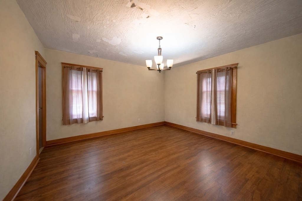 42 Morton Street Lawrence, MA 01841 - Photo 17 of 24 a view of an empty room with wooden floor and a window