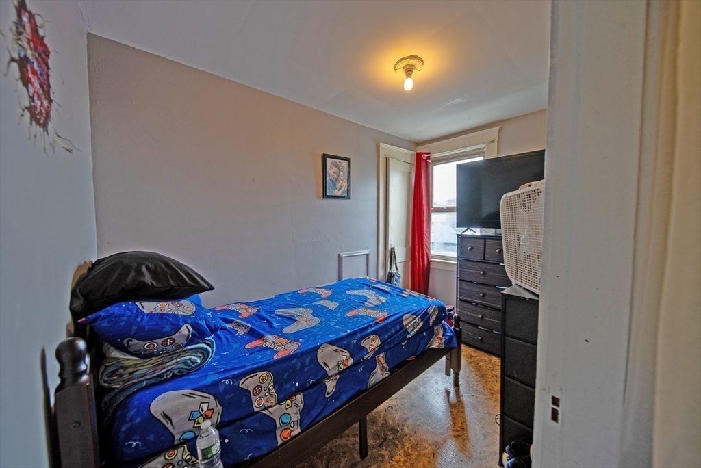 42 Morton Street Lawrence, MA 01841 - Photo 21 of 24 a bedroom with a bed and a window