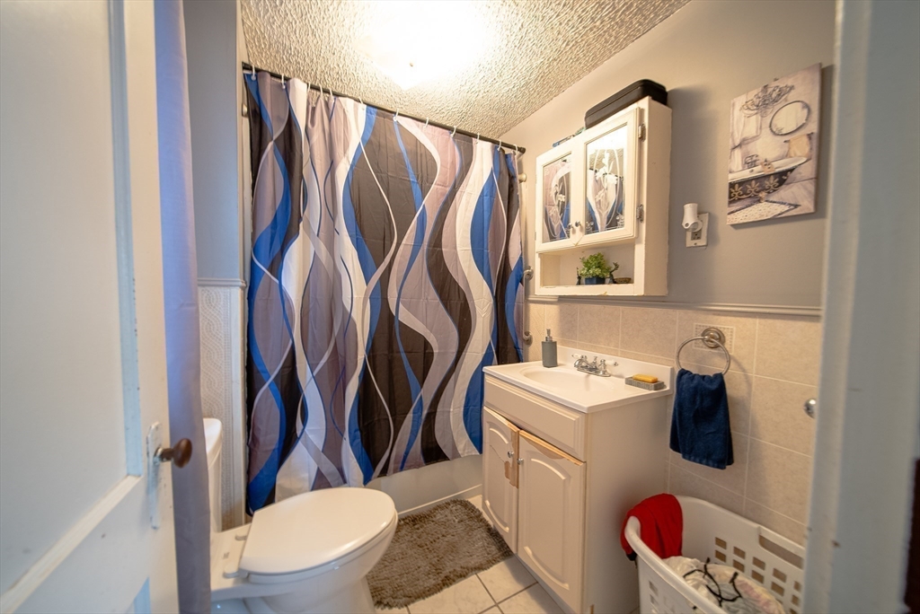 42 Morton Street Lawrence, MA 01841 - Photo 22 of 24 a bathroom with a sink toilet and shower