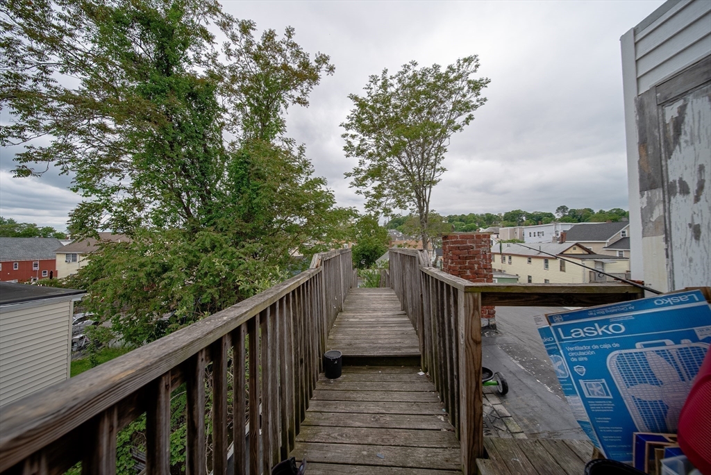 42 Morton Street Lawrence, MA 01841 - Photo 23 of 24 a view of balcony with outdoor seating and wooden floor
