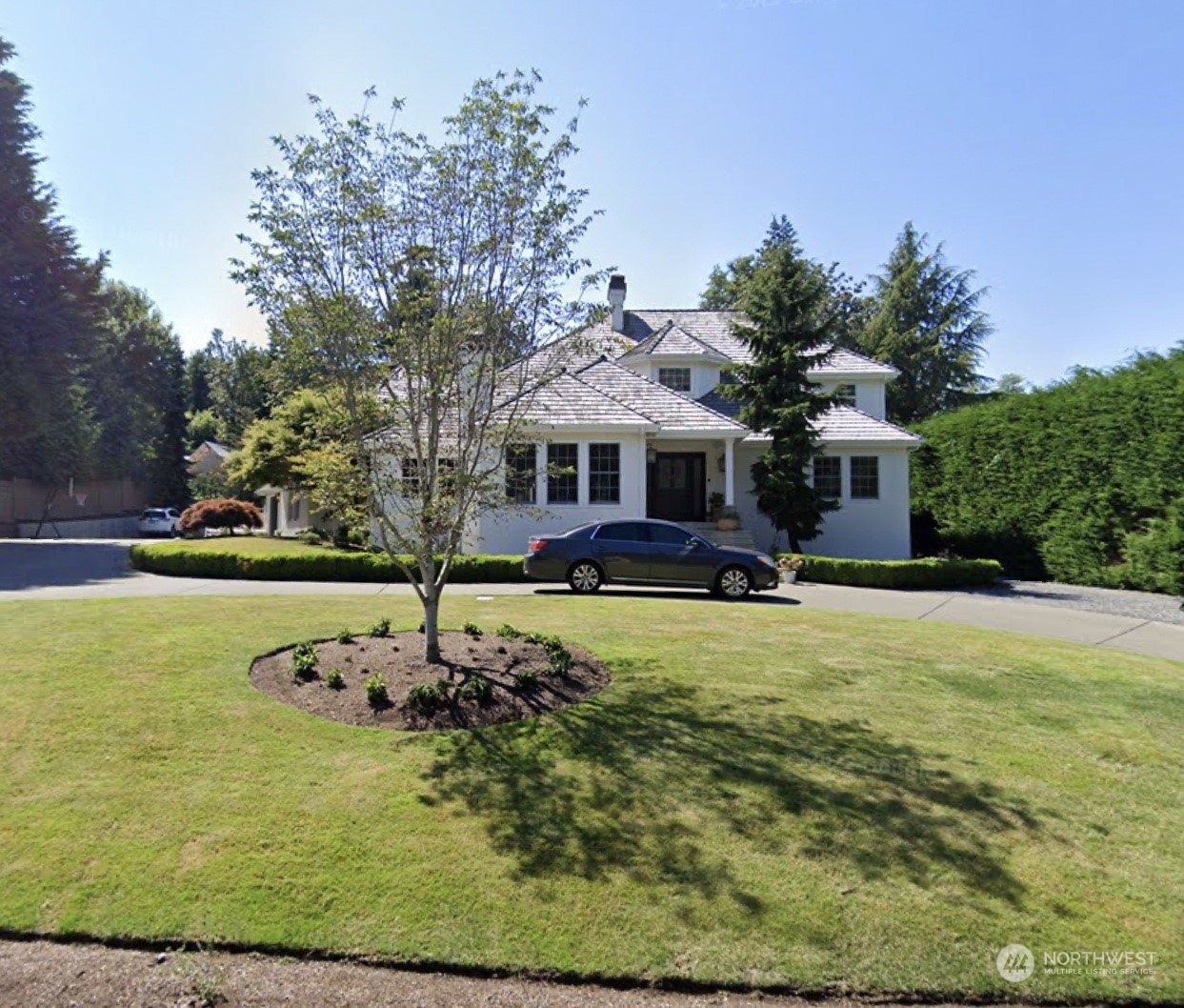 a front view of a house with swimming pool having outdoor seating