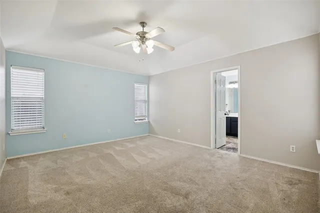 a spacious bedroom with a bed and a chandelier