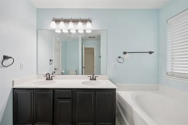 a bathroom with a bathtub and a sink