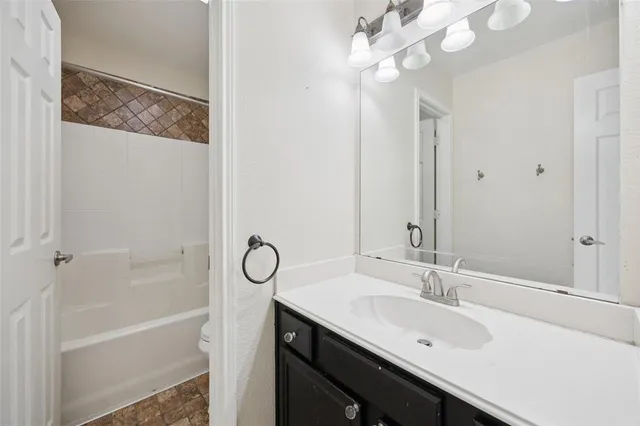 a view of a room with a ceiling fan and a window