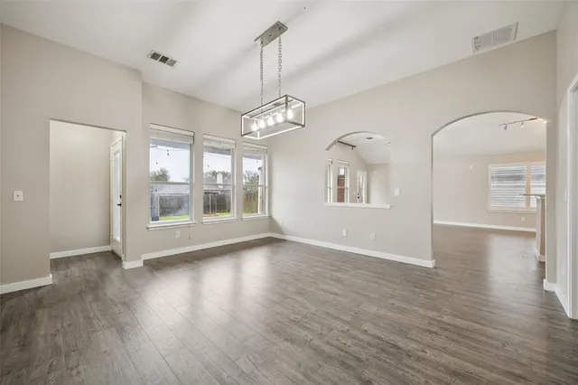 a view of livingroom with chandelier and wooden floor
