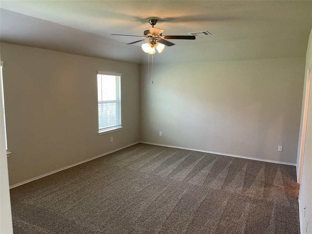 13872 Rock Island Trail Conroe, TX 77384 - Photo 12 of 32 an empty room with windows and fan