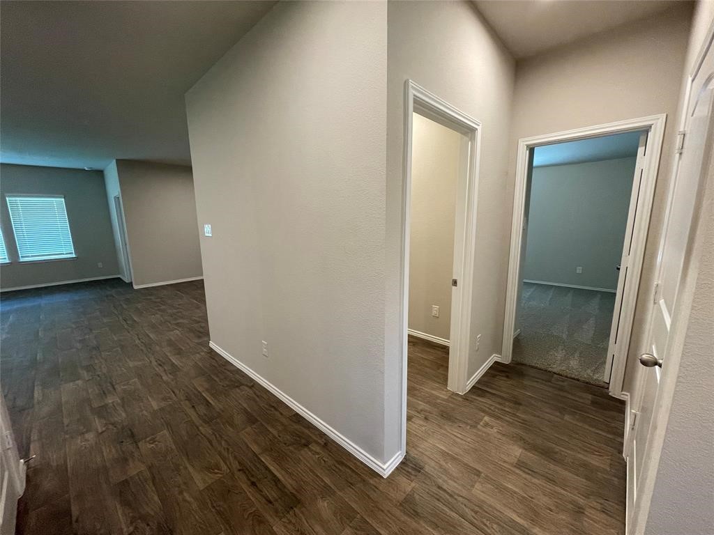 13872 Rock Island Trail Conroe, TX 77384 - Photo 15 of 32 an empty room with wooden floor and entrance