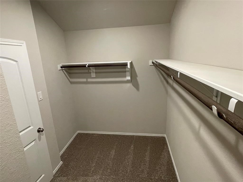 13872 Rock Island Trail Conroe, TX 77384 - Photo 18 of 32 a view of storage and utility room with racks on wall