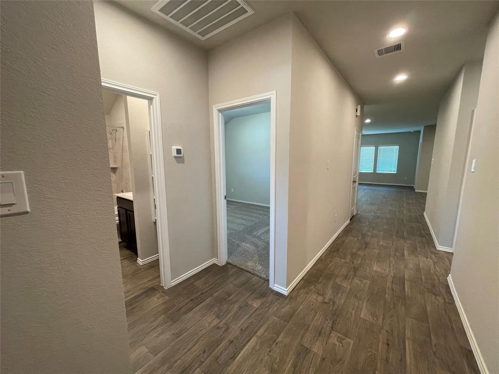 13872 Rock Island Trail Conroe, TX 77384 - Photo 20 of 32 wooden floor in a hall with an entryway
