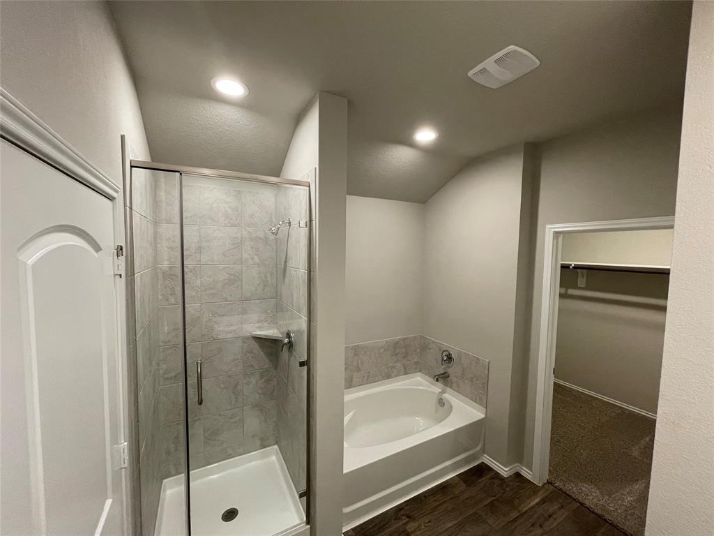 13872 Rock Island Trail Conroe, TX 77384 - Photo 22 of 32 a bathroom with a bathtub and a shower