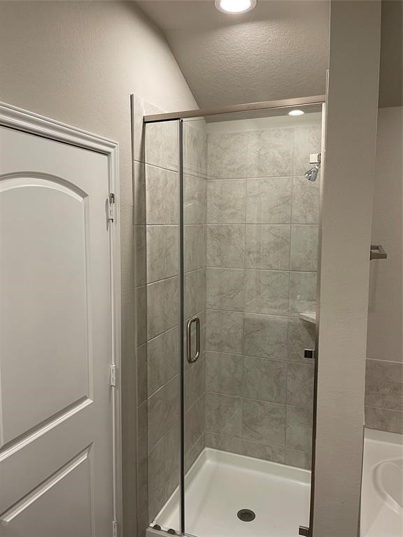 13872 Rock Island Trail Conroe, TX 77384 - Photo 23 of 32 a bathroom with a glass shower door