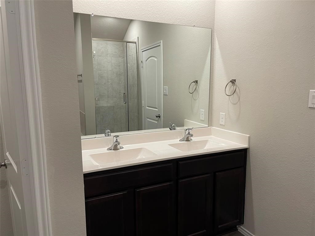 13872 Rock Island Trail Conroe, TX 77384 - Photo 24 of 32 a bathroom with a sink and a mirror
