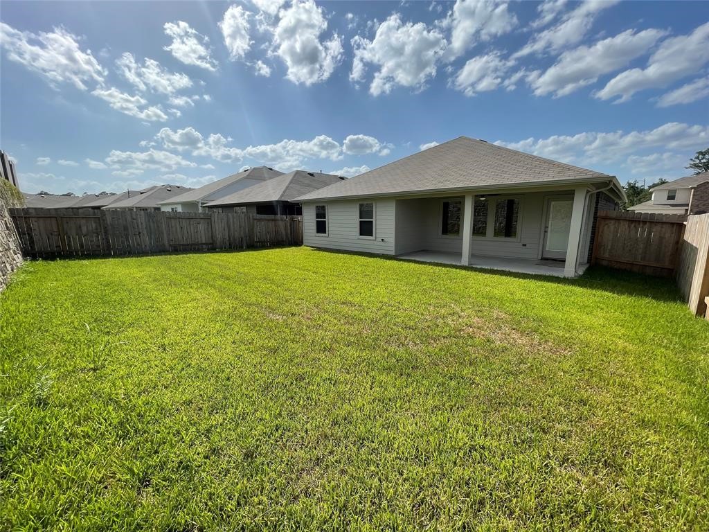 13872 Rock Island Trail Conroe, TX 77384 - Photo 31 of 32 a front view of a house with garden
