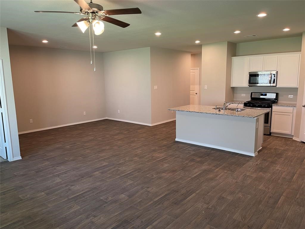 13872 Rock Island Trail Conroe, TX 77384 - Photo 4 of 32 an empty room with kitchen and view living room
