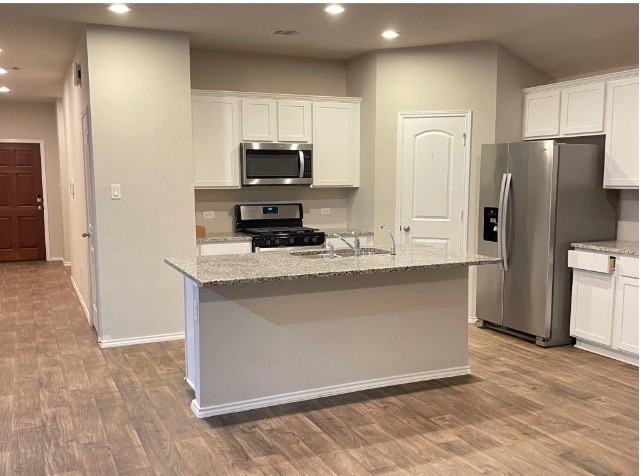 13872 Rock Island Trail Conroe, TX 77384 - Photo 5 of 32 a kitchen with stainless steel appliances a refrigerator a stove a microwave and cabinets