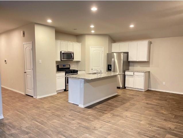 13872 Rock Island Trail Conroe, TX 77384 - Photo 6 of 32 a kitchen with a refrigerator and a stove top oven
