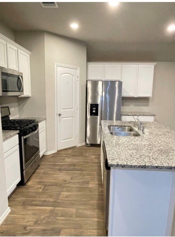 13872 Rock Island Trail Conroe, TX 77384 - Photo 7 of 32 a kitchen with stainless steel appliances granite countertop a sink stove and refrigerator