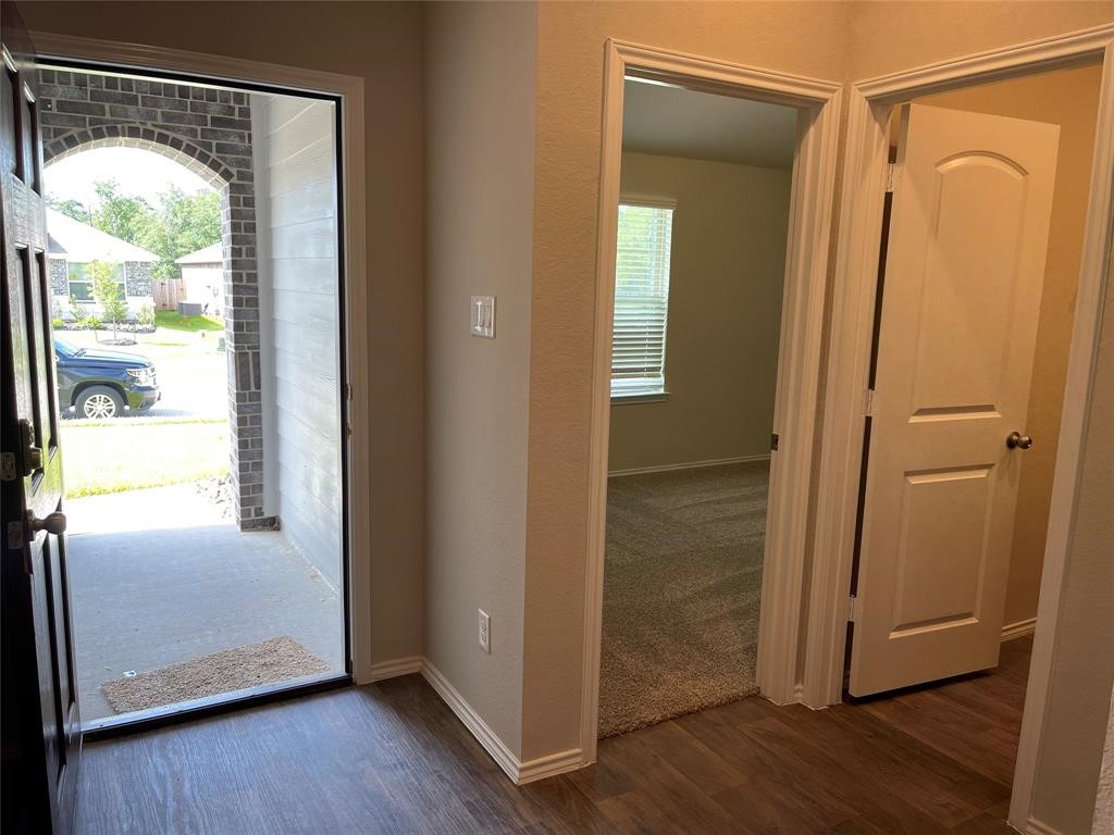 13872 Rock Island Trail Conroe, TX 77384 - Photo 9 of 32 a view of an empty room with wooden floor and a window