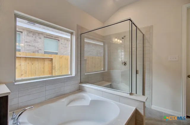 a bathroom with a bathtub and a shower