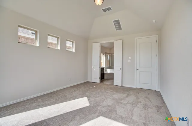 a view of a big room with windows and closet