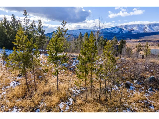 a view of a town with mountains in the background