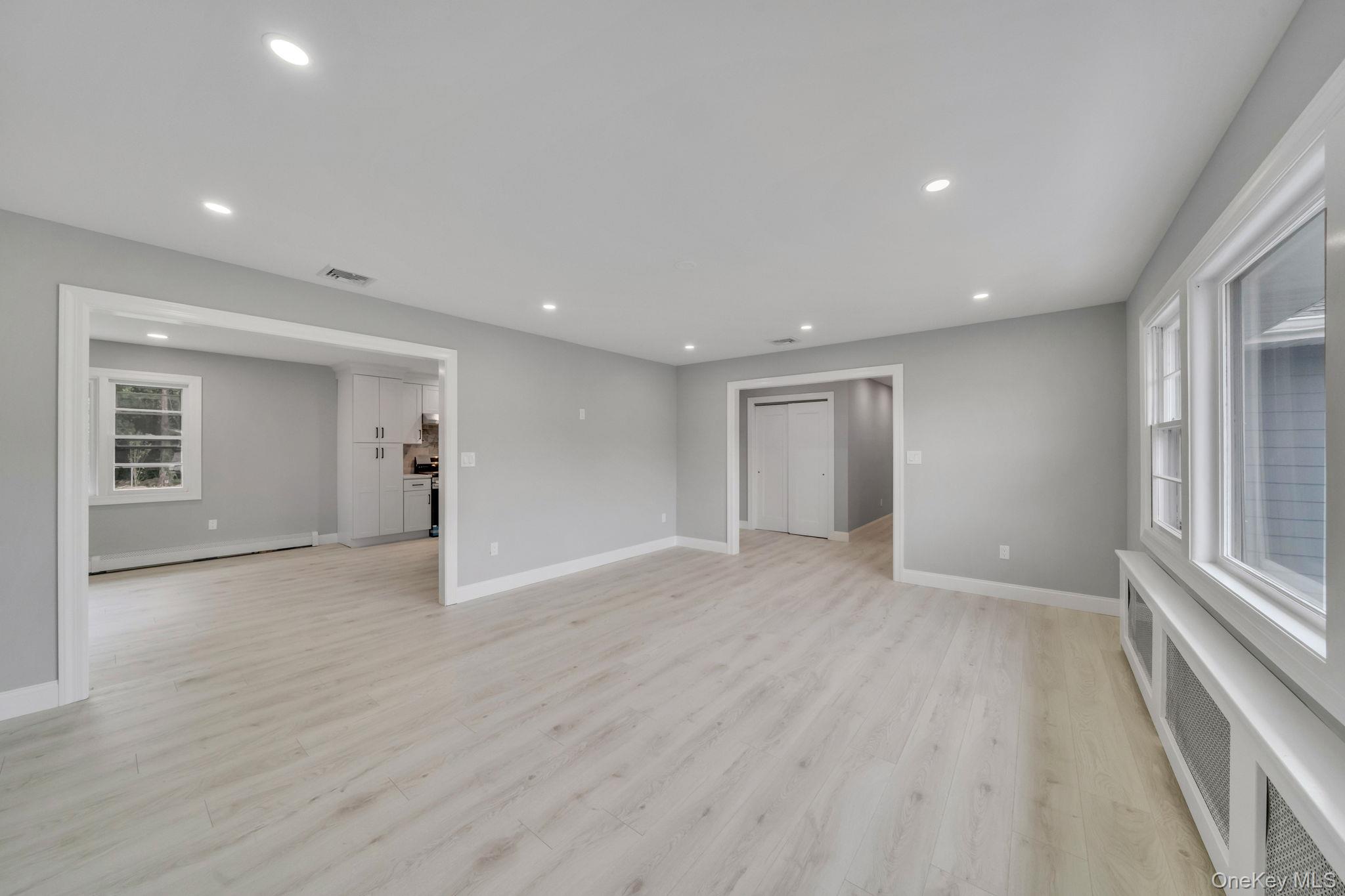 827 Aberdeen Road West Bay Shore, NY 11706 - Photo 16 of 40 Unfurnished living room featuring recessed lighting, light wood-style floors, and baseboard heating
