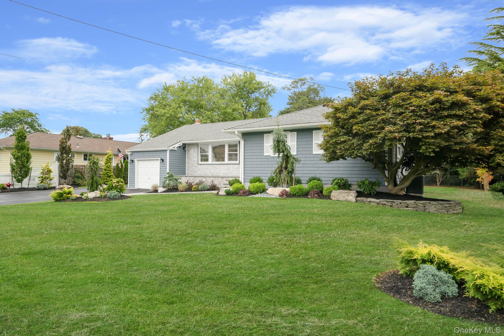 827 Aberdeen Road West Bay Shore, NY 11706 - Photo 3 of 40 View of front of home with a front lawn, an attached garage, a shingled roof, and driveway