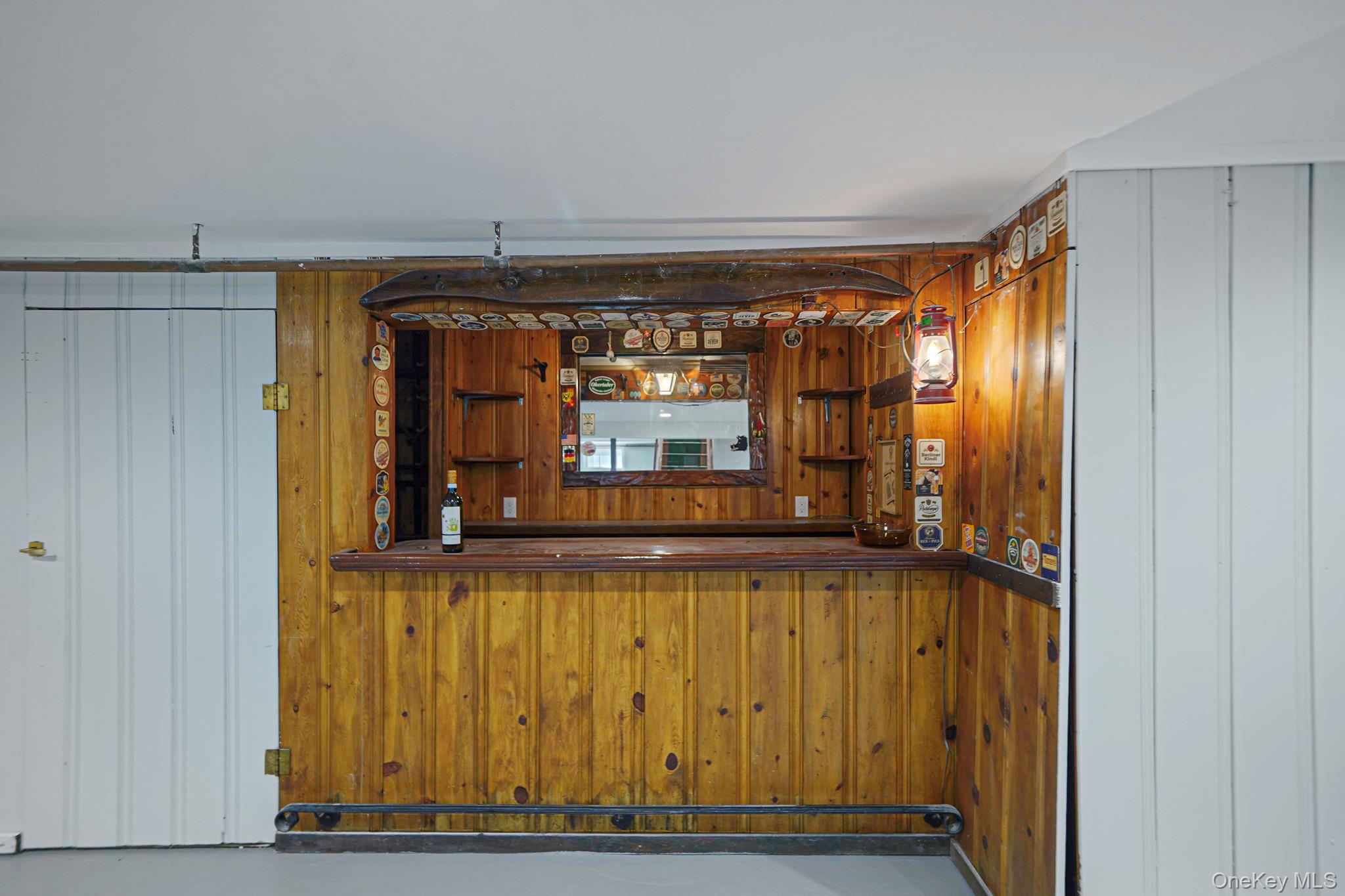 827 Aberdeen Road West Bay Shore, NY 11706 - Photo 33 of 40 Bar with wooden walls and concrete floors