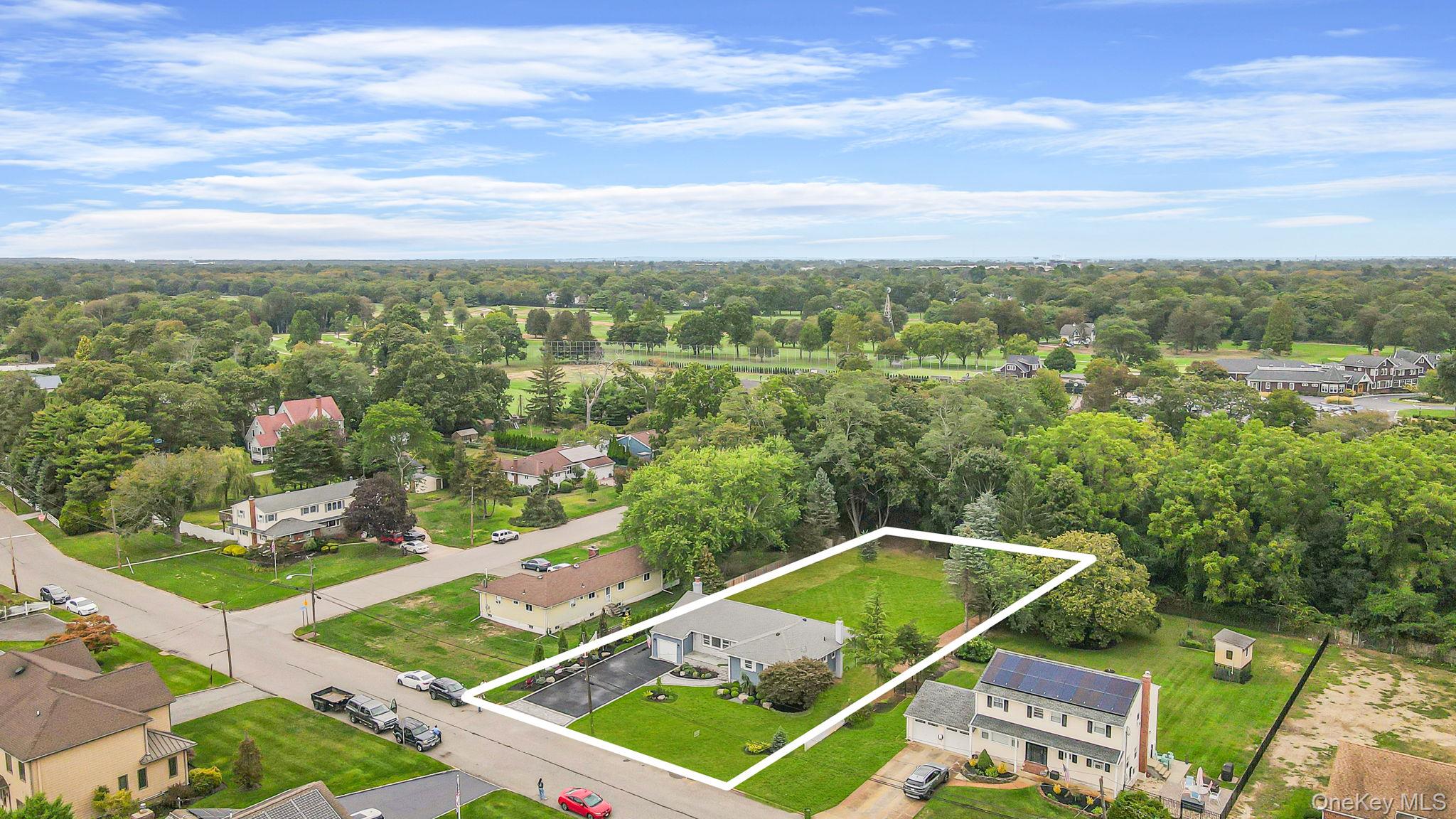 827 Aberdeen Road West Bay Shore, NY 11706 - Photo 4 of 40 Aerial perspective of suburban area with property parcel outlined