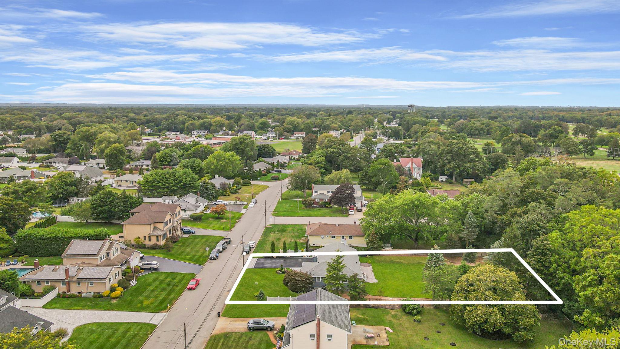 827 Aberdeen Road West Bay Shore, NY 11706 - Photo 5 of 40 Aerial view of residential area featuring property boundaries highlighted and a tree filled landscape
