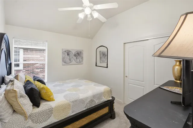 a bedroom with a bed and ceiling fan