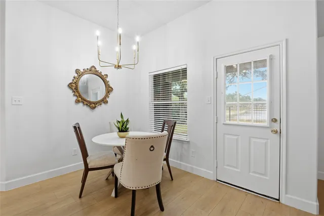 a view of a dining room with furniture wooden floor and chandelier