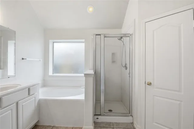 a front view of a house with a yard and potted plants