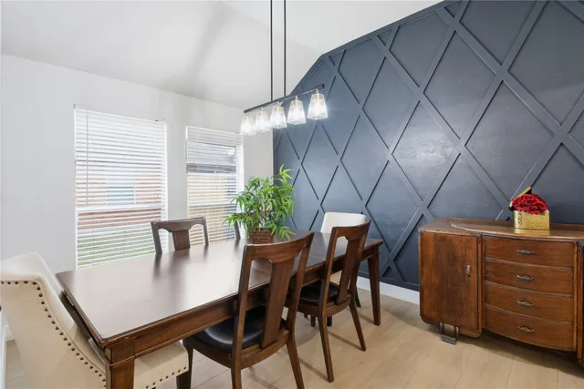 a view of a dining room with furniture and window