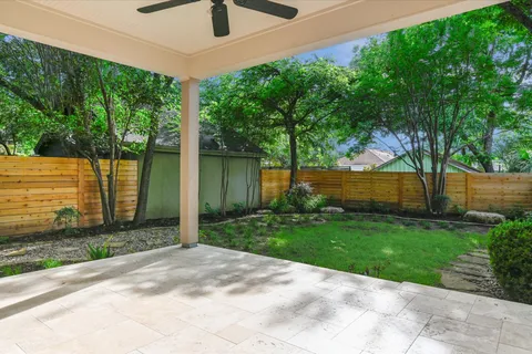 a view of a backyard with plants and a backyard